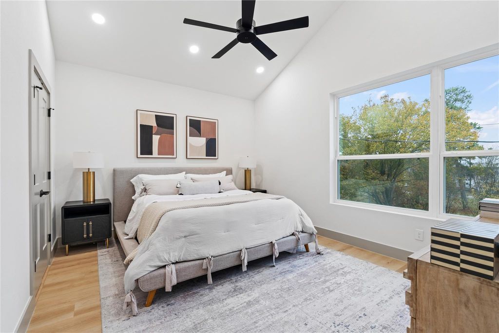 An expansive open-concept layout defined by ceiling height, clean sightlines, and abundant natural light—where living, dining, and kitchen spaces connect seamlessly through intentional design and proportion.